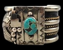 Sterling Silver, Gold And Turquoise Cuff Bracelet: For your bidding enjoyment we present a sterling silver, gold and turquoise cuff bracelet. This piece showcases a turquoise cabochon set in a sawtooth silver bezel, surrounded by a hand stamped plate 