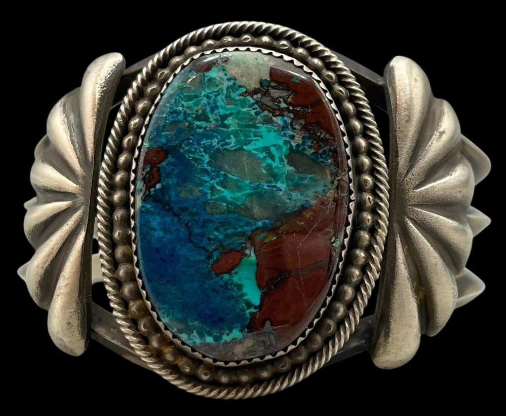 Sterling Silver And Chrysocolla Bracelet: For your bidding enjoyment we present a sterling silver and chrysocolla bracelet. This bracelet showcases a lovely chrysocolla cabochon set in a sawtooth silver bezel surrounded by twisted wire and si
