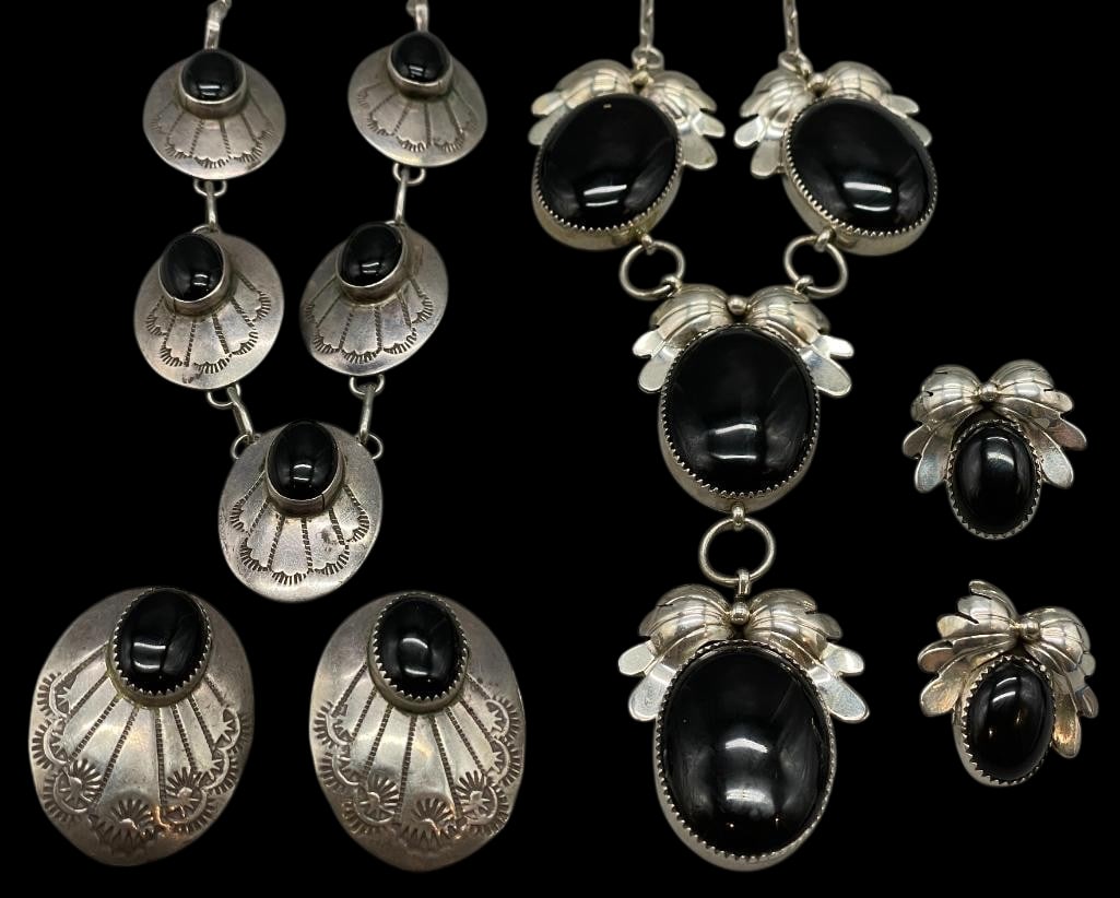 Sterling Silver And Onyx Group - Two Necklaces And Two Pair Of Earrings: Offered here is a sterling silver and onyx group - two necklaces and two pairs of earrings. This lot includes two coordinated necklace and earring sets. Each piece features onyx cabochons set in silve