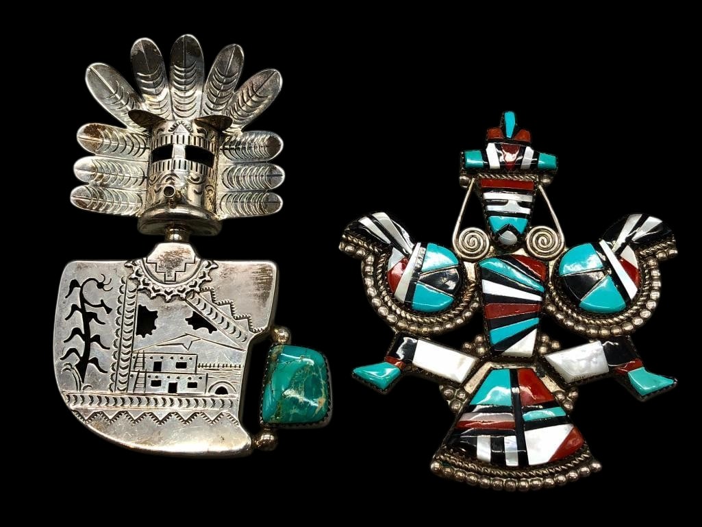 Two Sterling Silver Pendants - One Kachina And One Inlay: Available here are two sterling silver pendants - one Kachina and one inlay. One pendant features a Kachina motif created in silver work with hand stamped patterns and cutout details. A turquoise cabo