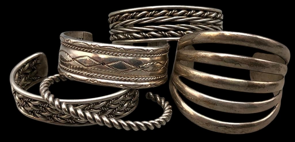Five Sterling Silver Bracelets: Offered here for your consideration are five sterling silver bracelets. These pieces are highlighted with hand stamped and twisted wire designs. Two of the bracelets are finished with a cuff while one