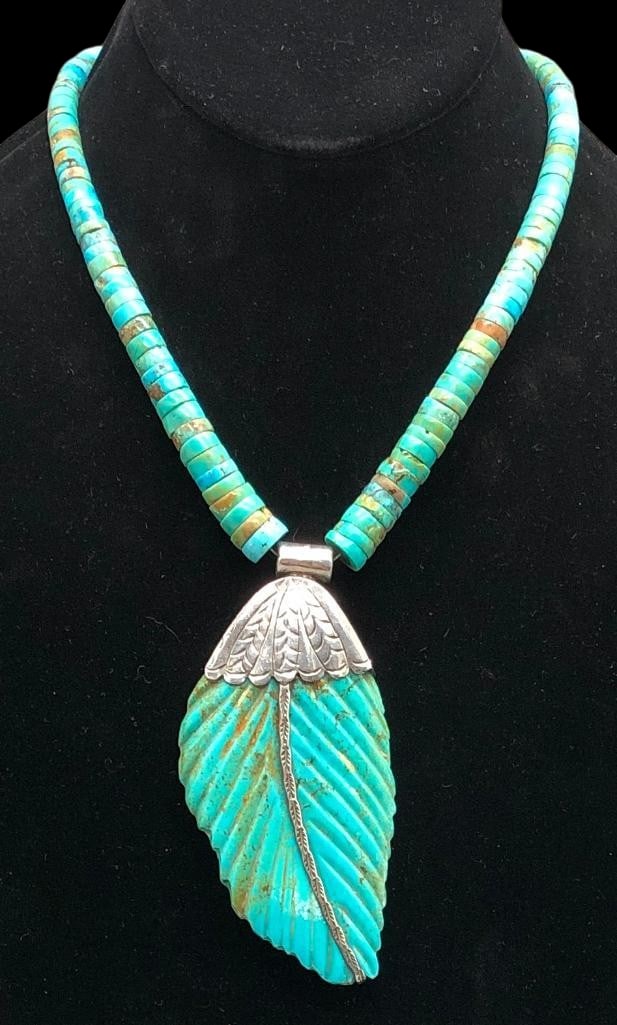 Carved Leaf Turquoise Necklace: Offered here for your consideration is a carved leaf turquoise necklace. This piece features a carved leaf turquoise pendant set in a scalloped sterling silver bezel accented with hand stamped designs