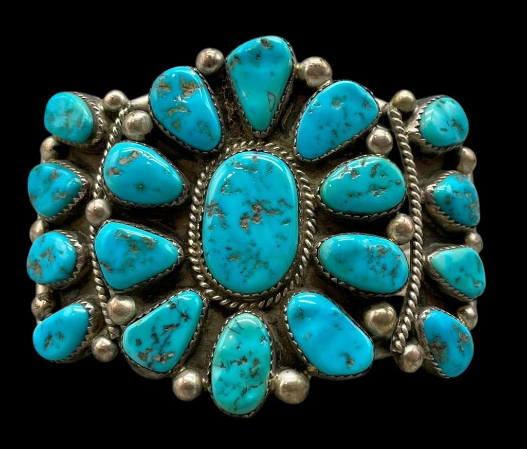 Sterling Silver And Turquoise Cluster Bracelet: Offered here for your consideration is a sterling silver and turquoise cluster bracelet. This piece feature a cluster of turquoise cabochons set in sawtooth silver bezels. Accenting the stones are sil