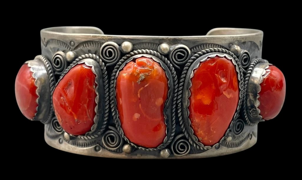 Five Stone Coral And Sterling Silver Bracelet: For your bidding enjoyment we present a five stone coral and sterling silver bracelet. This bracelet features coral cabochons set in scalloped silver bezels. The stones are on a solid silver cuff acce