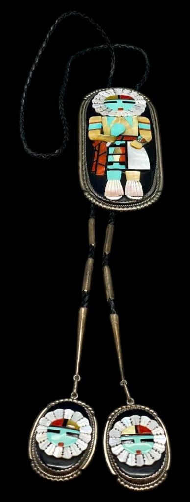 Beverly Etsate Kachina Theme Bolo Tie: Offered here for your consideration is a Beverly Etsate Kachina theme bolo tie. The sterling silver slide features a raised multi stone Kachina design inlay of turquoise, coral and mother of pearl on 