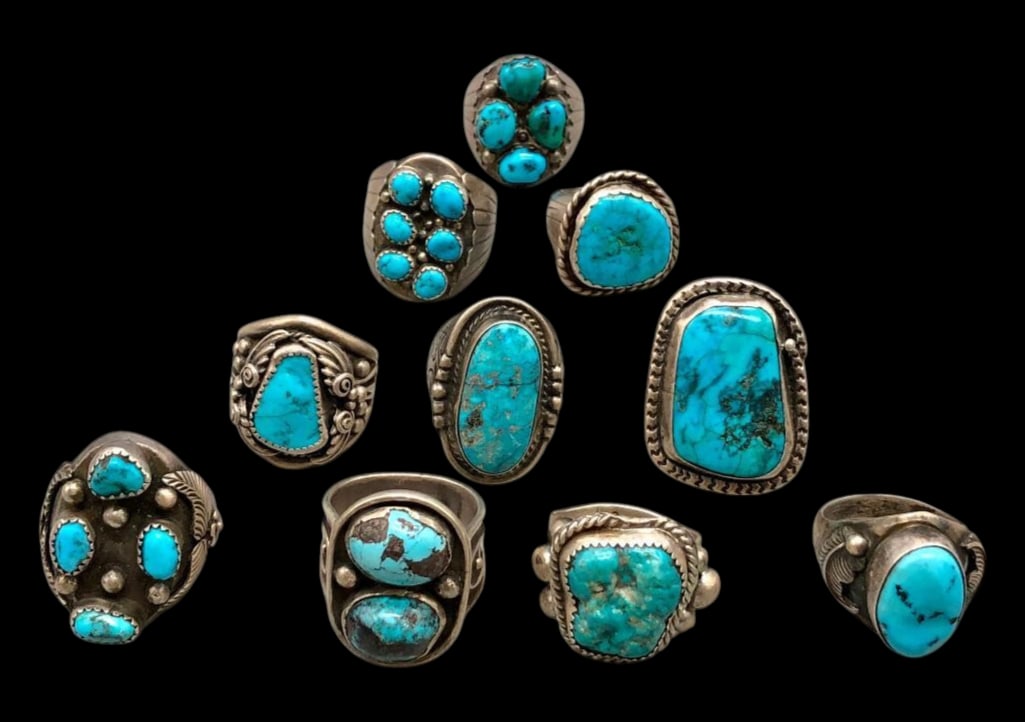 10 Sterling Silver And Turquoise Rings: Offered here are 10 sterling silver and turquoise rings. These pieces are each highlighted with turquoise cabochons set in silver bezels. Accenting the stones is a variety of silver work including