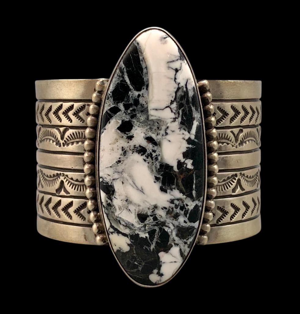 Sterling Silver and White Buffalo Bracelet By Rick Enriquez: Offered here for your consideration is a sterling silver and White Buffalo bracelet by Rick Enriquez. This piece features a White buffalo cabochon set in smooth silver bezel accented with silver dots 