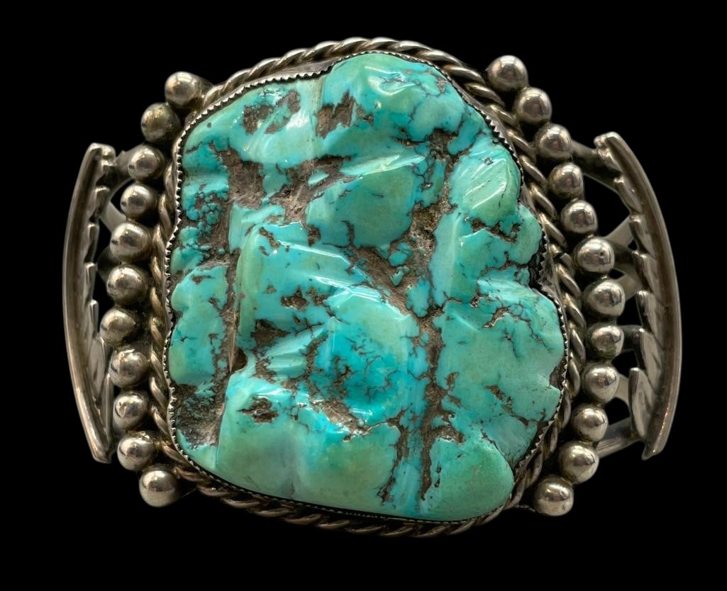 Vintage Chunky Carved Turquoise And Sterling Silver Bracelet: Offered here for your consideration is a vintage chunky carved turquoise and sterling silver bracelet. This piece features a large carved turquoise cabochon set in a sawtooth silver bezel. Accenting t
