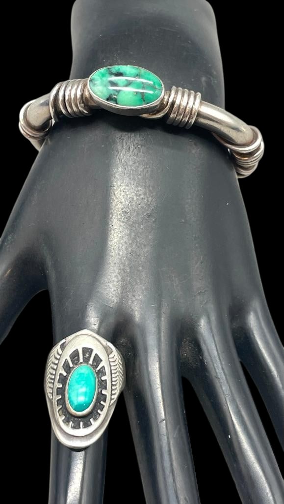 Orville Tsinnie Sterling Silver Bracelet And Ben Nighthorse Ring: Offered here is an Orville Tsinnie sterling silver bracelet and Ben Nighthorse ring. This bracelet features a turquoise cabochon set in a smooth silver bezel atop a hefty cuff accented with wrapped wi