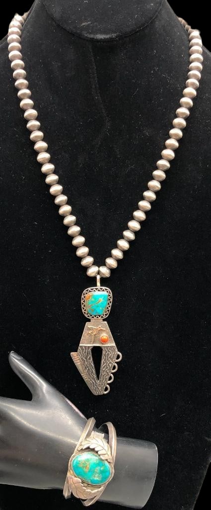 Sterling Silver, Turquoise Coral And 14K Gold Pendant Necklace With Bracelet: Offered here are a sterling silver, turquoise, coral and 14K gold pendant necklace with bracelet. This necklace features a striking pendant centered with a beautiful turquoise cabochon set in a smooth