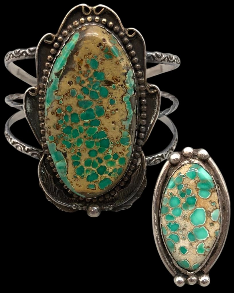 Sterling Silver And Turquoise Bracelet And Ring: Offered here is a sterling silver and turquoise bracelet and ring. Both pieces are highlighted by a turquoise cabochon set in a silver bezel. Surrounding the stones is an array of detailed silver work