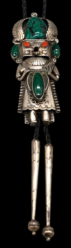 Kachina Theme Sterling Silver, Malachite And Coral Bolo Tie: Offered in this lot is a Kachina themed sterling silver, malachite and coral bolo tie. This slide has a Kachina design highlighted with malachite and coral cabochons. Accenting the stones are leaves, 