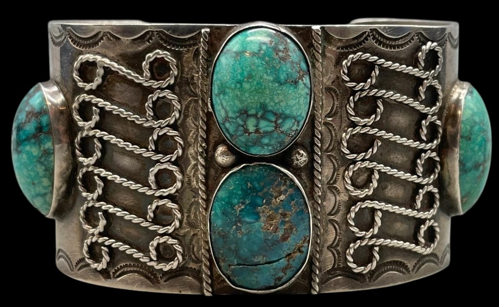 Vintage-Antique Sterling Silver And Turquoise Bracelet: For your bidding enjoyment we present a vintage-antique sterling silver and turquoise bracelet. This solid cuff features four turquoise cabochons set in smooth silver bezels. Surrounding the stones ar