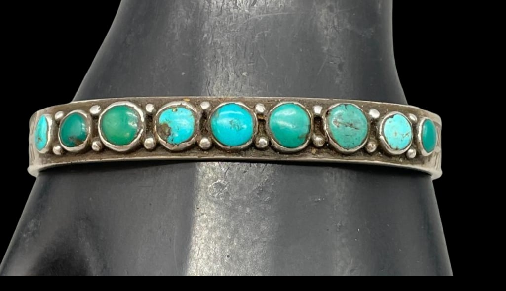 1920s Ingot Sterling Silver And Turquoise Row Bracelet: For your bidding enjoyment we present a 1920s ingot sterling silver and turquoise row bracelet. This bracelet features a row of natural turquoise cabochons in round shapes all set in smooth silver bez
