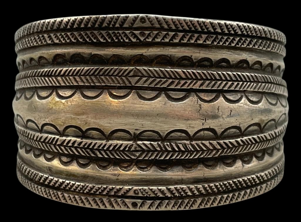 Hefty Handmade Coin Silver Bracelet By Jock Favour: For your bidding enjoyment we present a hefty handmade coin silver bracelet by Jock Favour. This solid cuff has a great weight to it and features hand stamped designs from end to end. Further highligh