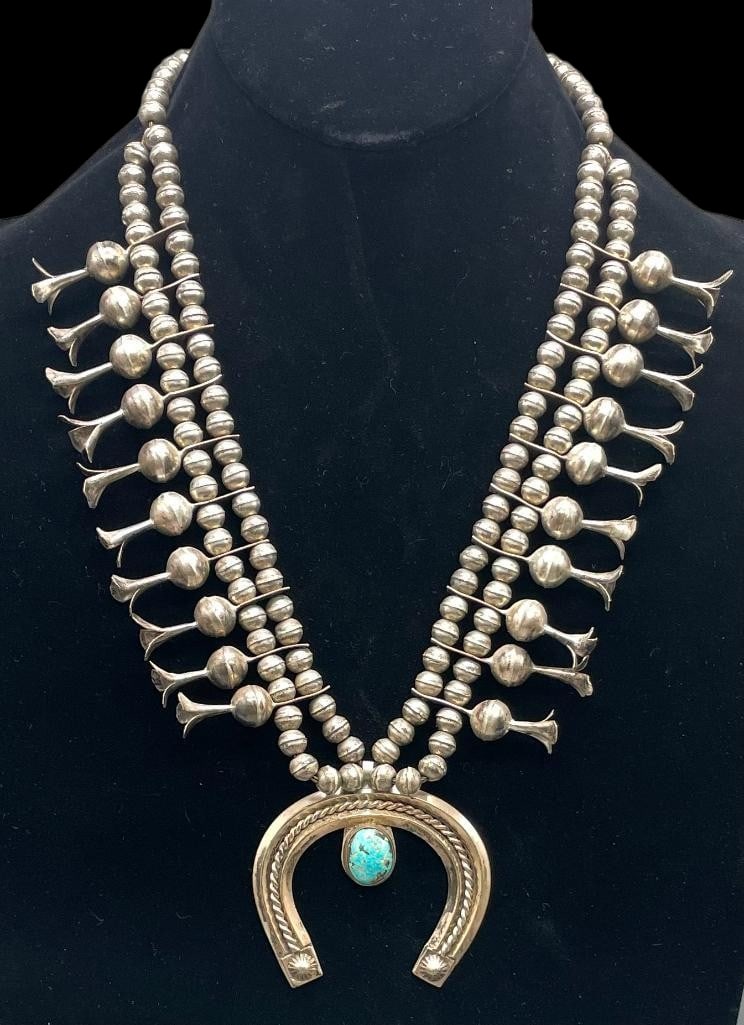 Sterling Silver And Turquoise Squash Blossom Necklace: Offered here for your consideration is a sterling silver and turquoise squash blossom necklace. This necklace features a three wire naja highlighted with a turquoise cabochon set in a smooth silver be