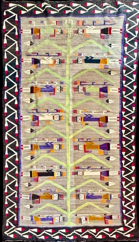 Very Large Pictorial Navajo Rug With Yei Figures Circa 1950s: Available here for your consideration is a very large pictorial Navajo rug with Yei figures from circa the 1950s. This is a rare weaving with a cornstalk design in the center surrounded by feathers