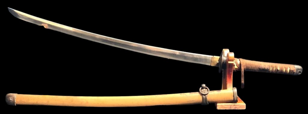 World War II Era Japanese Katana - Sword: Offered here for your consideration is a World War II era Japanese Katana - sword. It features a curved, single edged steel blade highlighted with a round metal tsuba and brass habaki collar. The