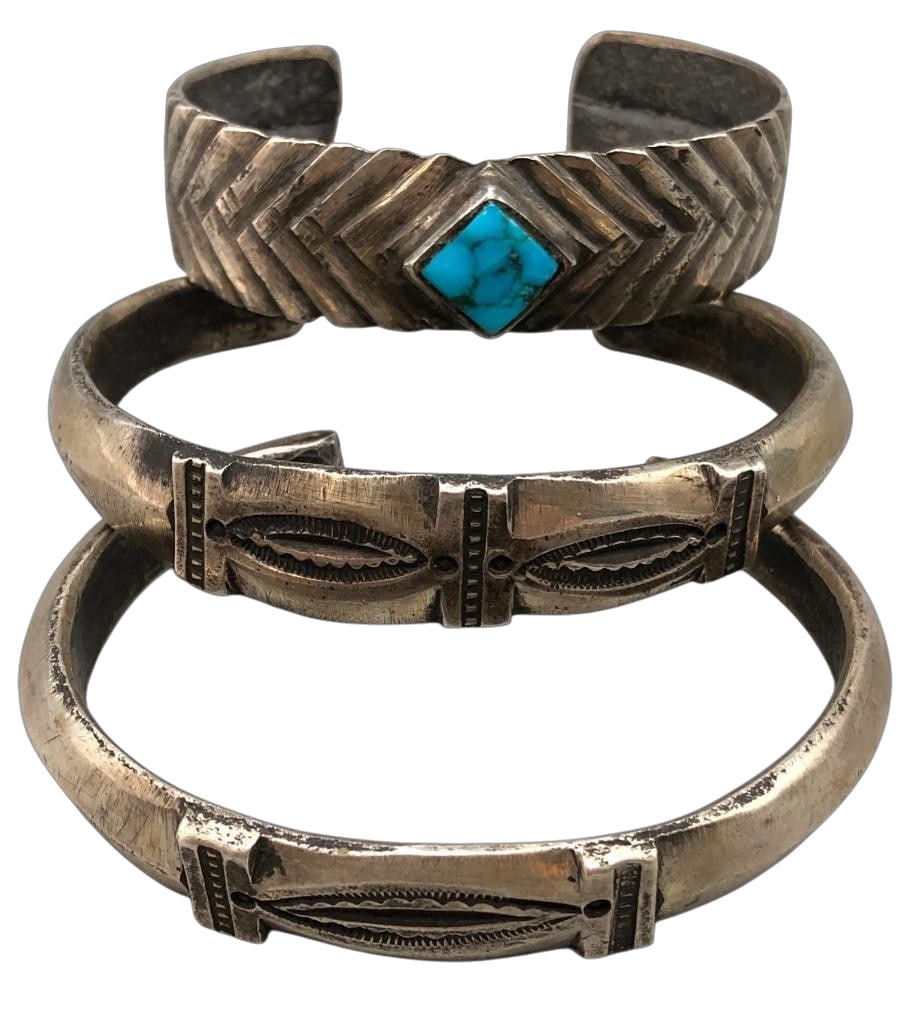 Three Coin Silver Bracelets By Jock Favour: Offered here for your consideration are three coin silver bracelets by Jock Favour. Each piece features hand stamped designs with one further highlighted by a turquoise cabochon set in smooth silver b