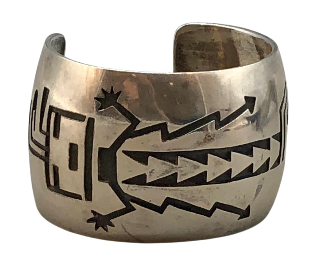 Sterling Silver And Overlay Bracelet by Manuel And Karen Hoyungowa: Offered here for your consideration is a sterling silver and overlay bracelet by Manuel and Karen Hoyungowa. This piece features a Kachina overlay design on a darkened silver background. The bracelet 