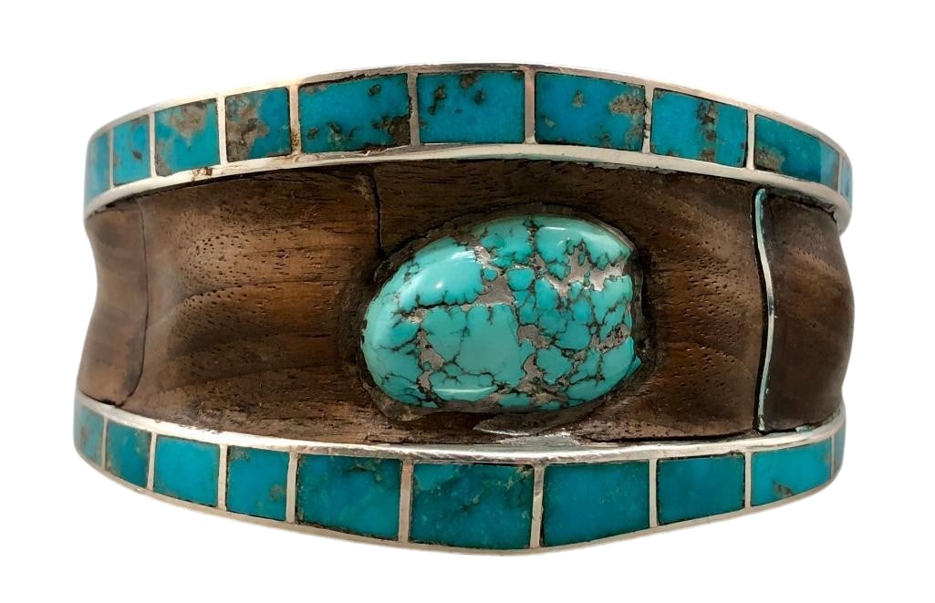 Sterling Silver Ironwood And Turquoise Bracelet: For your bidding enjoyment we present a sterling silver, ironwood and turquoise bracelet. This bracelet features a central turquoise cabochon surrounded by ironwood inlay. The designs are on a solid s