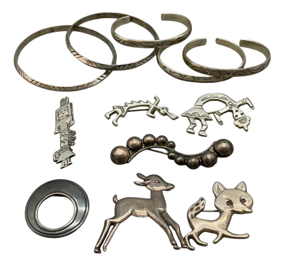 Group of Sterling Silver Jewelry: Offered here for your consideration is a group of sterling silver jewelry. The pins feature a variety of designs, including Kachina and animal motifs. The bracelets showcase hand stamped designs on so