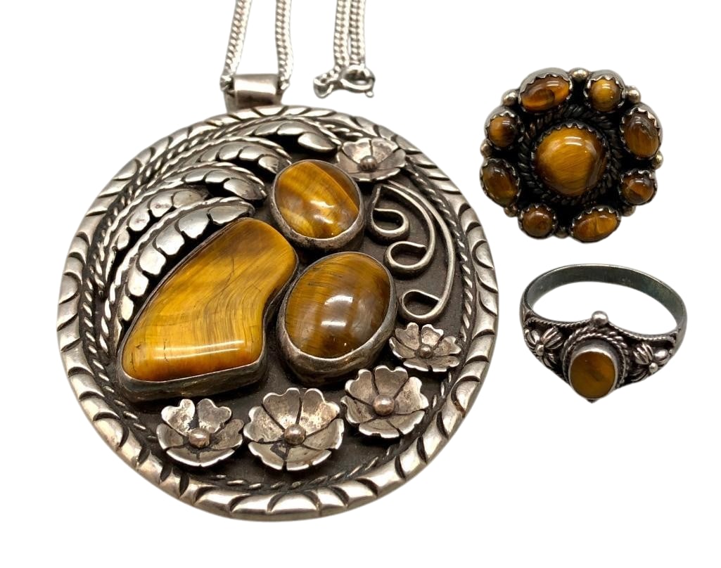 Sterling Silver And Tiger's Eye Pendant With Two Rings: Offered here for your consideration is a sterling silver and Tiger's Eye pendant with two rings. Each piece features Tiger's Eye cabochons set in silver bezels. Accenting the stones are leaves