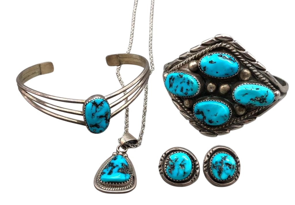 Two Turquoise And Sterling Silver Bracelets, Pair of Earrings And Pendant: Offered here for your consideration are two turquoise and sterling silver bracelets, pair of earrings, and a pendant. Each piece features turquoise cabochons set in sawtooth silver bezels. Accenting t