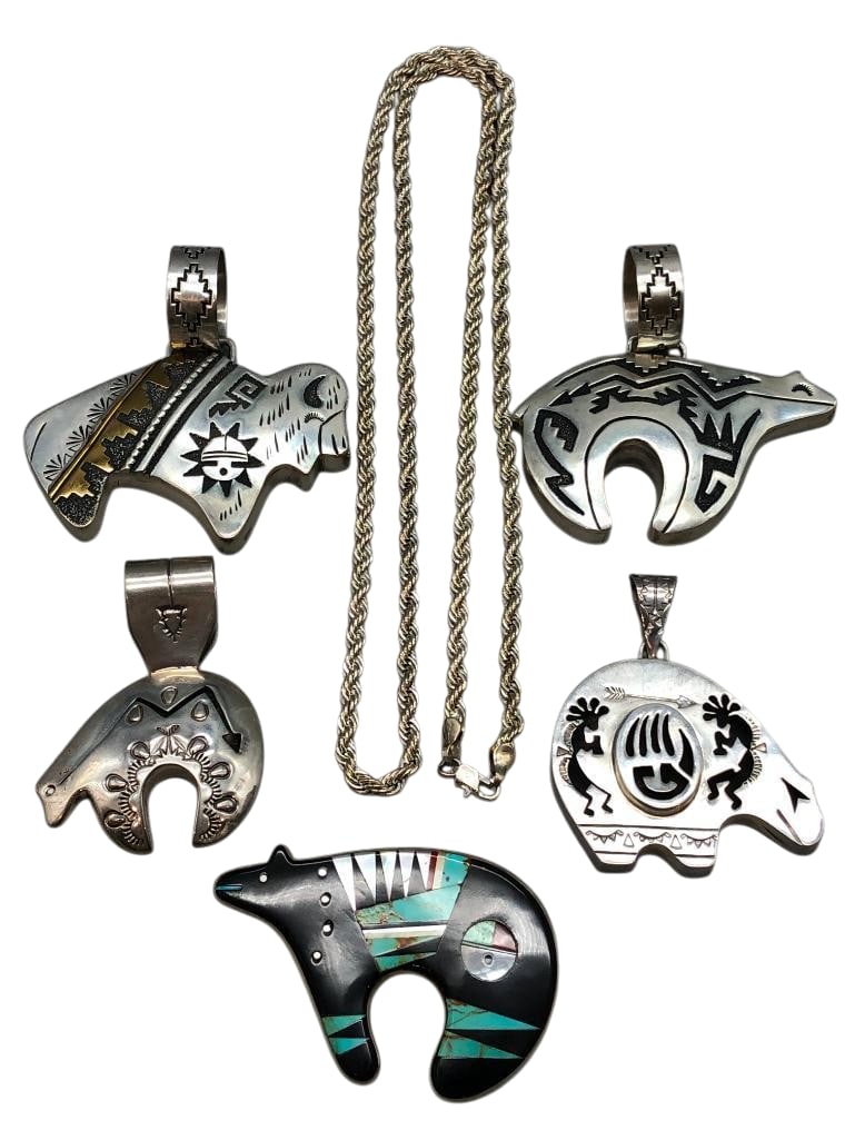 Five Miscellaneous Sterling Silver Pendants And Chain: Available here are five miscellaneous sterling silver pendants and chain. This lot features something for everyone. These pendants each feature a bear or buffalo motif. Accenting them is a variety of 