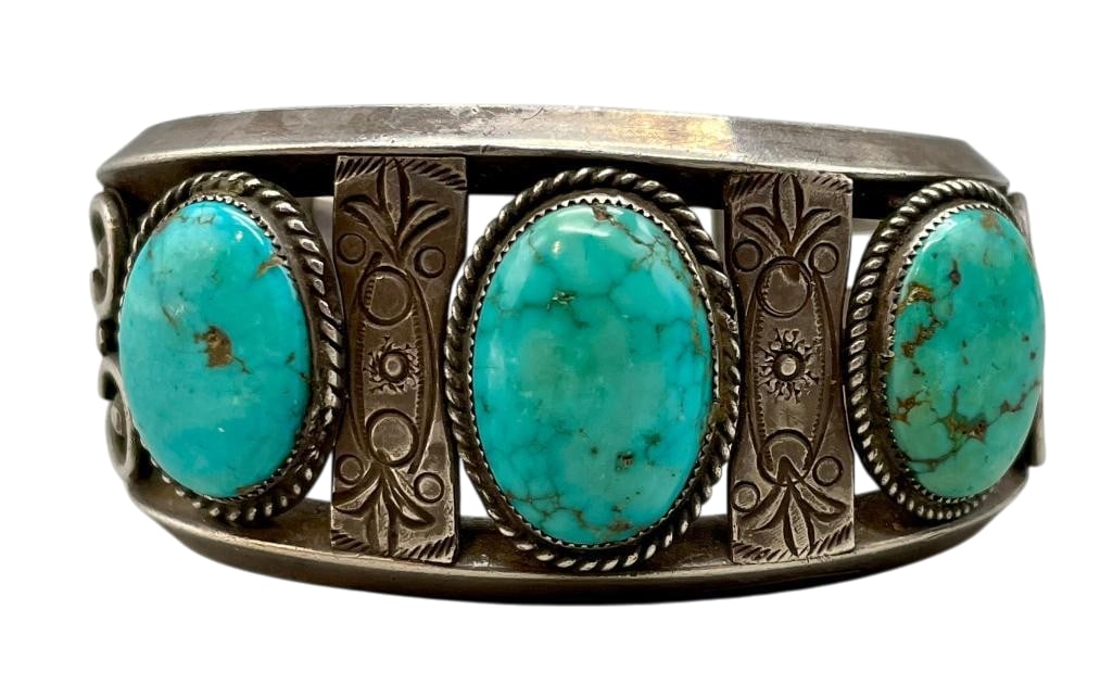 Mid Century Turquoise And Sterling Silver Bracelet: For your bidding enjoyment we present a mid century turquoise and sterling silver bracelet. This bracelet features three turquoise cabochons set in sawtooth silver bezels surrounded by twisted wires. 