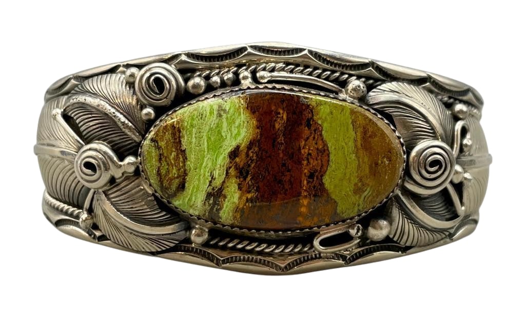 Gaspeite And Sterling Silver Bracelet by Daniel Martinez: For your bidding enjoyment we present a gaspeite and sterling silver bracelet by Daniel Martinez. This bracelet features a gaspeite cabochon set in a sawtooth silver bezel. The stone is on a solid sil