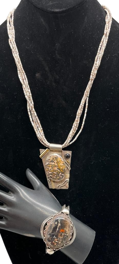 Sterling And Petrified Wood Bracelet And Sterling, 14K Gold, Picture Jasper And Heishi Necklace: Offered here are a sterling silver petrified wood bracelet and sterling silver, 14K gold, picture jasper and Heishi necklace. This necklace features a pendant highlighted with a picture jasper cabocho