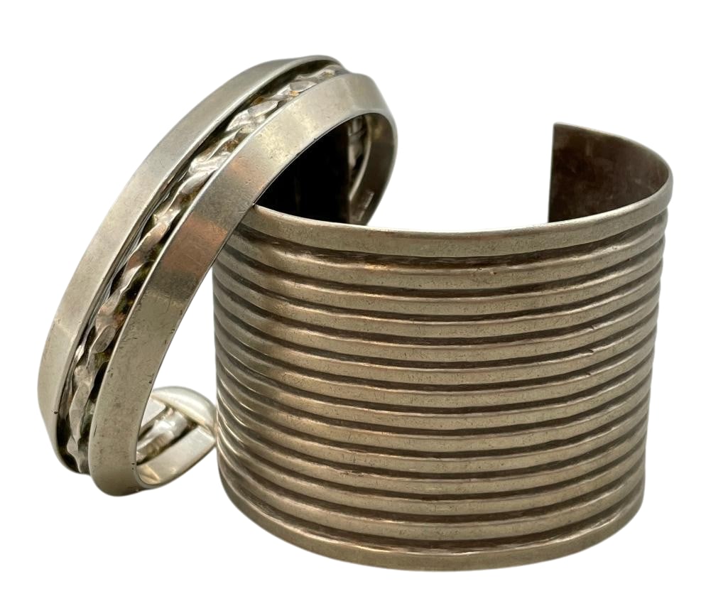 Two Sterling Silver Bracelets: Available here for your consideration are two sterling silver bracelets. The first bracelet features a wide solid cuff with a row design. The second has a three wire terminal including a central twist
