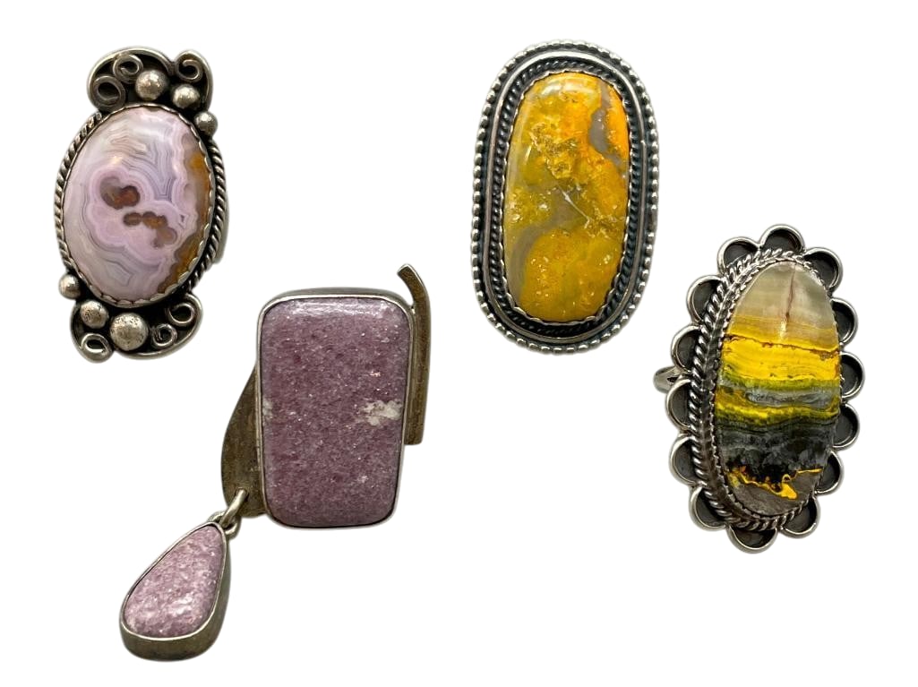 Four Sterling Silver Rings With Various Stones: Offered here are four sterling silver rings with various stones. These pieces are highlighted with cabochons in Bumble Bee Jasper, Purple Jasper and Agate set in silver bezels. Accenting the designs i