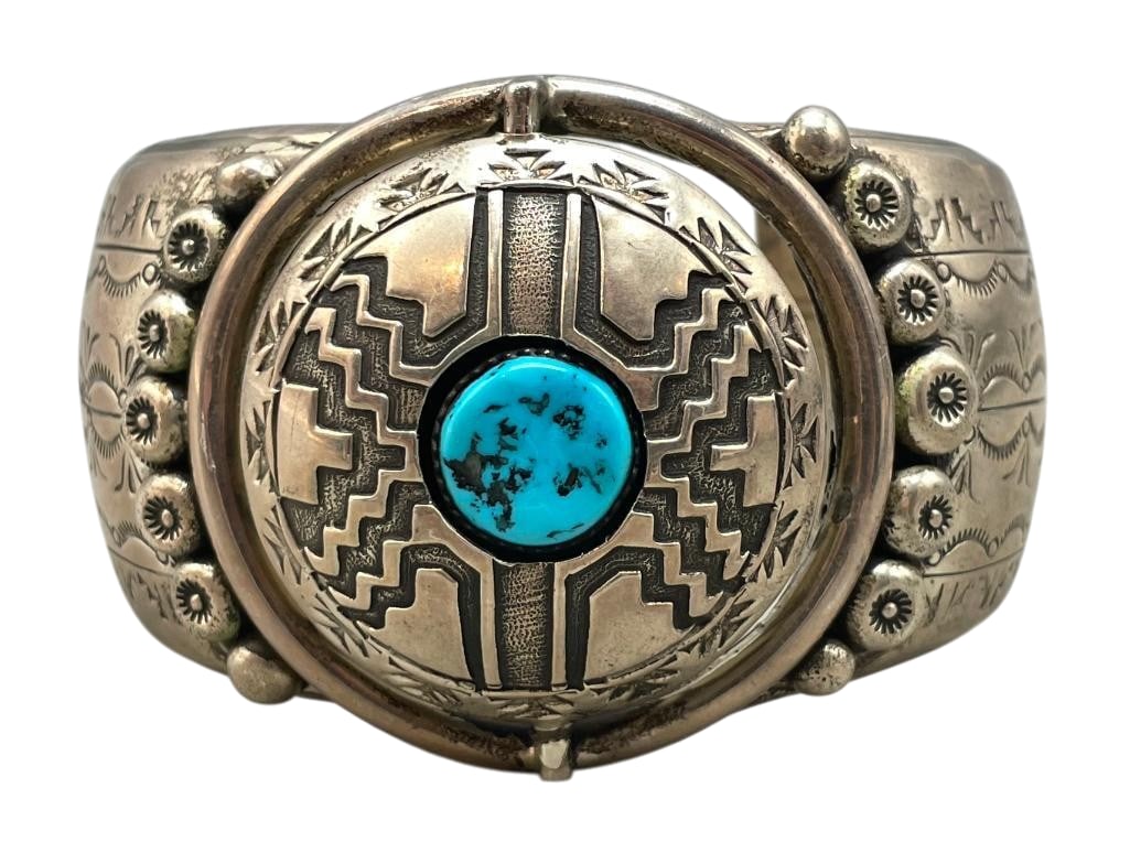STATEMENT Sterling Silver Spinner Bracelet By Leo Nez: Available here is a statement sterling silver spinner bracelet by Leo Nez. This piece features a double sided spinning center. One side features a turquoise cabochon set in a silver sawtooth bezel sur