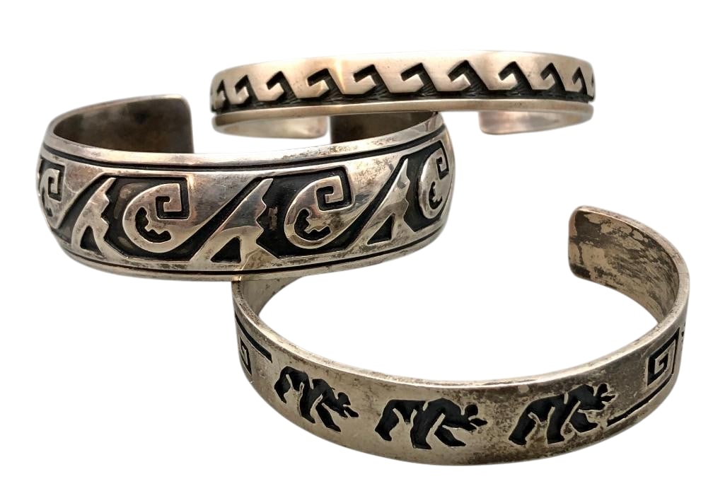 Three Sterling Silver Overlay Style Bracelets: Offered here for your consideration are three sterling silver overlay style bracelets. Each piece features overlay style designs on darkened silver backgrounds. Patterns include bears or geometrics. C