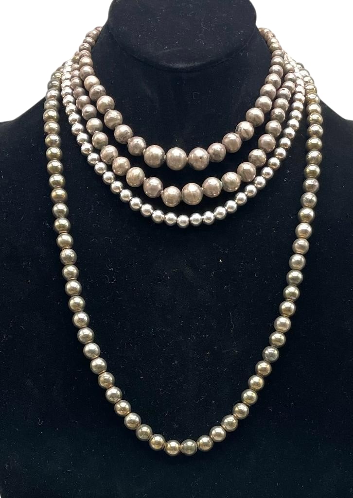 Four Sterling Silver Beaded Necklaces: Offered here for your consideration are four sterling silver beaded necklaces. These pieces feature one to two strands of sterling silver beads strung on a chain or a cord. They are in a variety of le