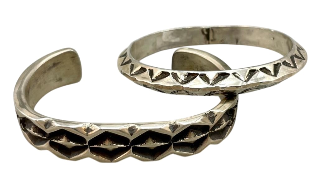Two Hefty Sterling Silver Bracelets: Offered here for your consideration are two hefty sterling silver bracelets. One bracelet is a carinated bangle with hand stamped patterns. The other piece is a hefty solid silver cuff with cast and d