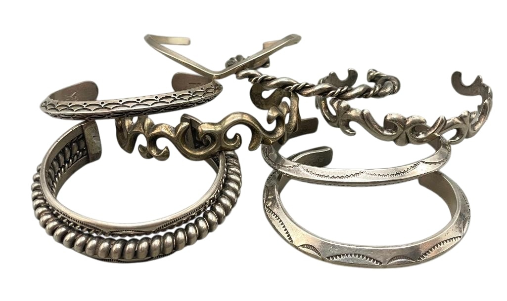 Eight Sterling Silver Bracelets With Various Designs: Offered here for your consideration are eight sterling silver bracelets with various designs. Three of the solid cuffs feature a carinated design accented with hand stamped patterns. Two additional cu