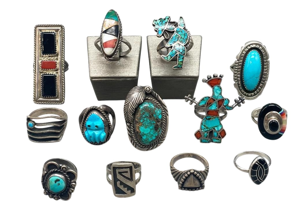 13 Sterling Silver Rings With Various Settings: Offered here are 13 sterling silver rings with various settings. These pieces feature a variety of designs including turquoise, onyx, coral, and other cabochons, as well as multi stone and chip inlays