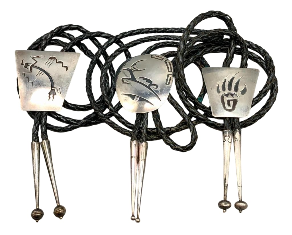 Three Sterling Silver Bolos By Willie Yazzie: Available here for your consideration are three sterling silver bolos by Willi Yazzie. These slides each feature a different overlay design accented with darkened backgrounds. The patterns include a b
