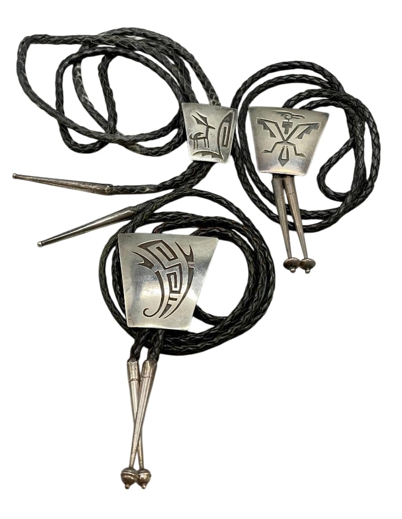 Three Sterling Silver Bolos By Willie Yazzie Sr.: Available here for your consideration are three sterling silver bolos by Willie Yazzie Sr. These slides feature overlay designs of animals and geometrics with darkened backgrounds. They are each on a 