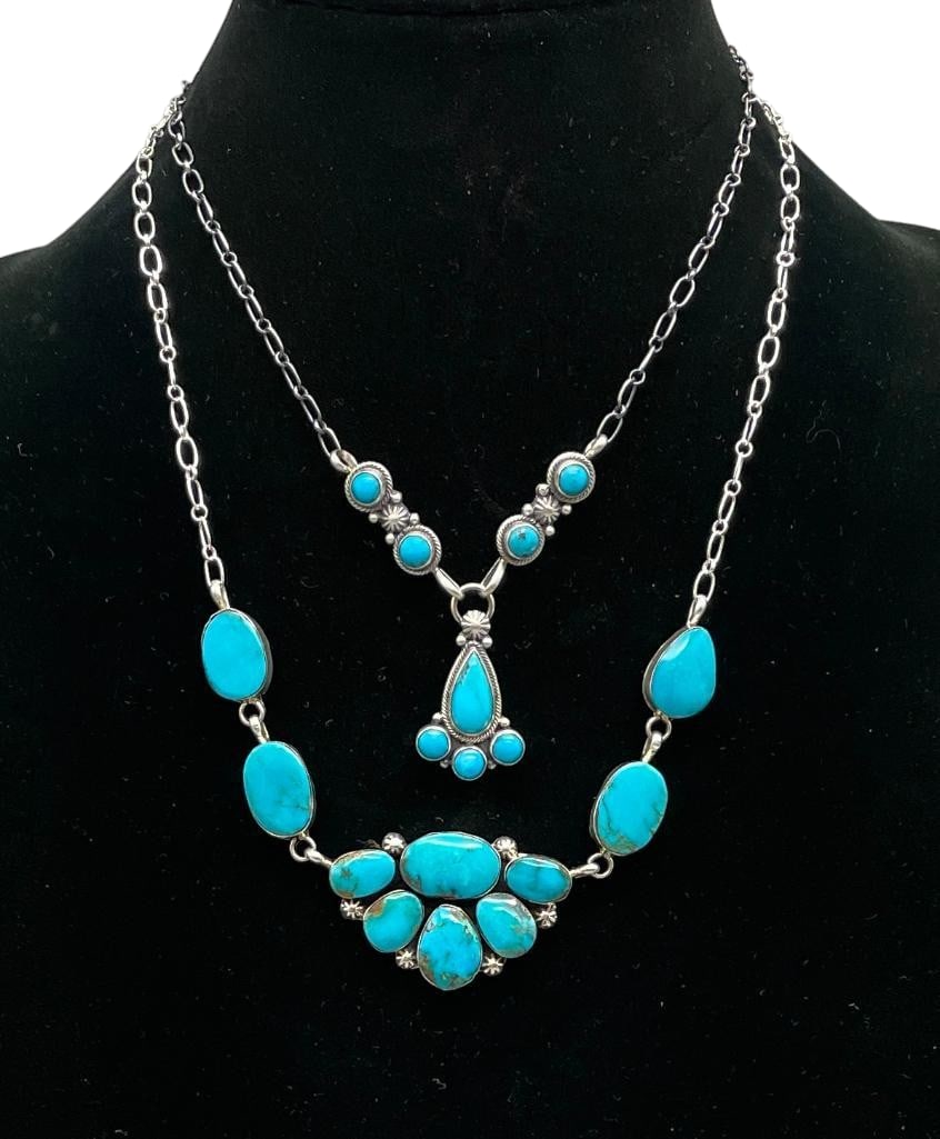 Two Contemporary Sterling Silver And Turquoise Necklaces: Offered here for your consideration are two contemporary sterling silver and turquoise necklaces. Both pieces feature pendants highlighted with turquoise cabochons set in smooth silver bezels. Accenti