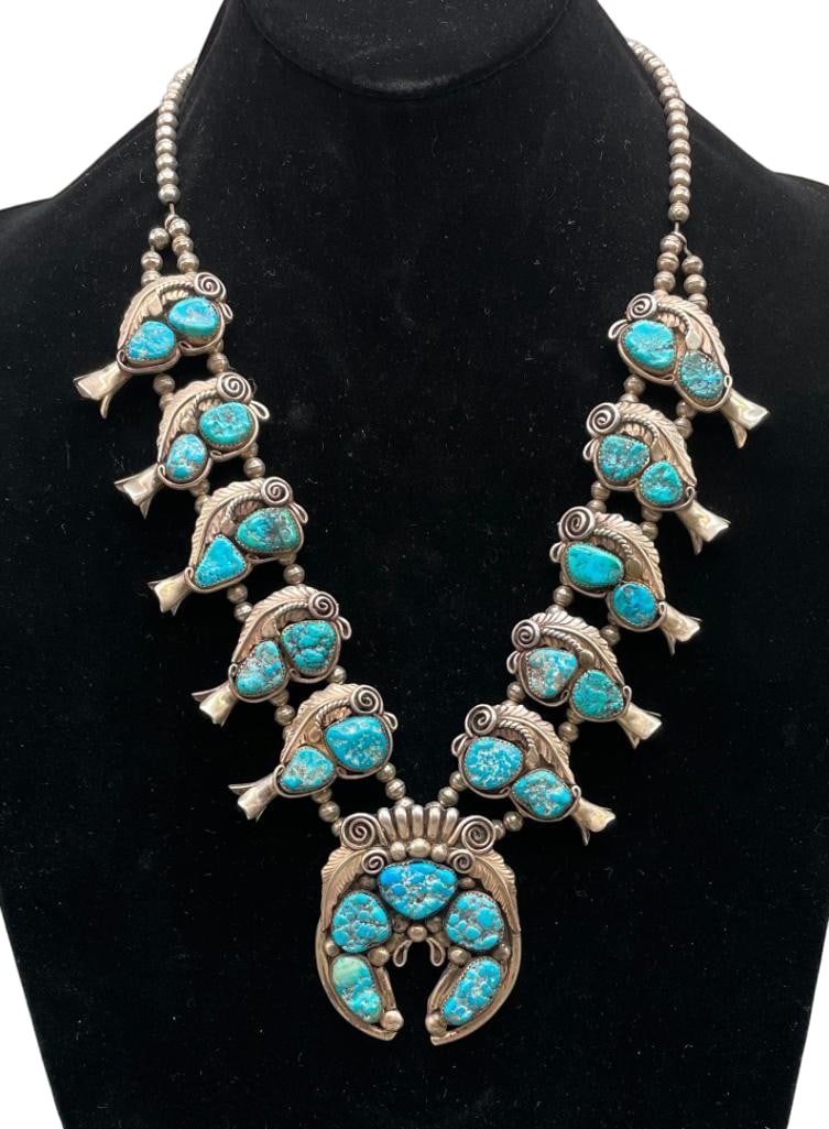 Vintage Sterling Silver And Turquoise Squash Blossom Necklace: Offered here for your consideration is a vintage sterling silver and turquoise squash blossom necklace. The naja features five turquoise nugget cabochons set in sawtooth silver bezels accented with le