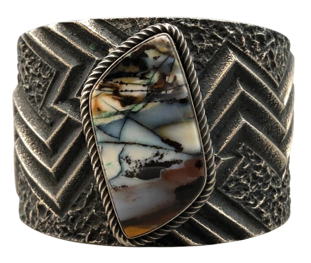 Wide Hefty Tufa Cast Bracelet By Kevin Yazzie: For your bidding enjoyment we present this wide hefty tufa cast bracelet by Kevin Yazzie. This bracelet features an agate cabochon set in a smooth silver bezel surrounded by twisted wire. It is finish