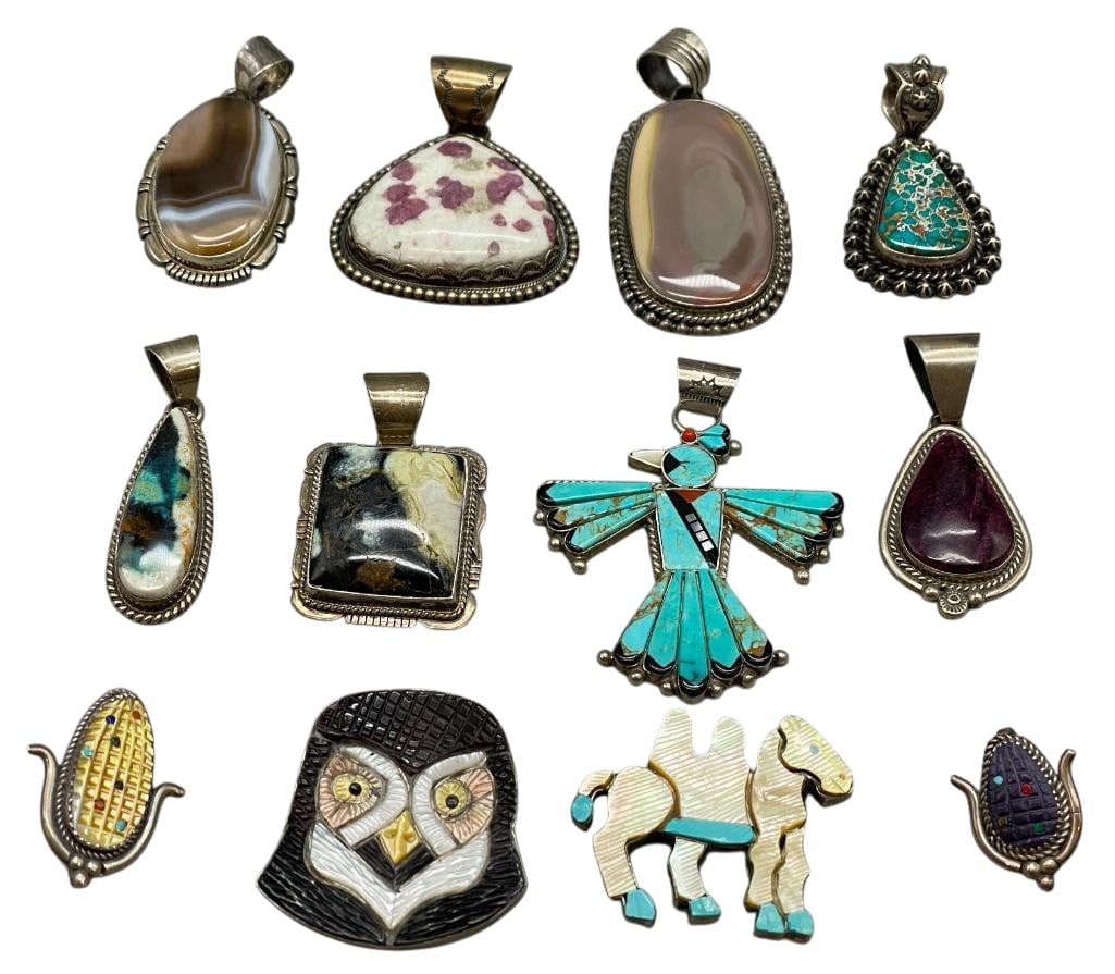 Group of 12 Sterling Silver Pendants by Various Artists: Available here is a group of 12 sterling silver pendants by various artists. This lot features something for everyone. These pendants showcase a variety of different designs, including cabochons, carv