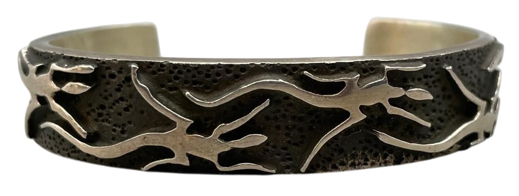 Sterling Silver Lizard Theme Bracelet By Danny Romero: For your bidding enjoyment we present a sterling silver lizard theme bracelet by Danny Romero. This solid silver cuff features lizard motifs from end to end. Set against a darkened, textured silver ba