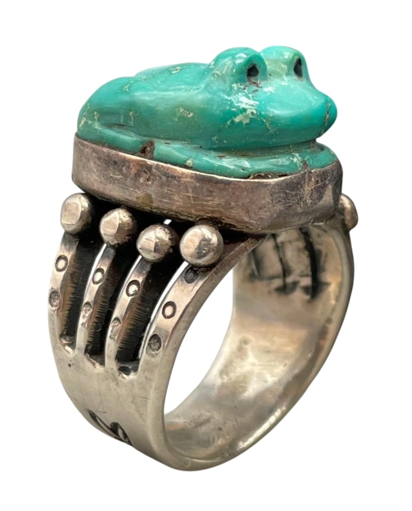 Sterling Silver Ring With Carved Turquoise Frog By Jock Favour: Offered here for your consideration is a sterling silver ring with carved turquoise frog by Jock Favour. This ring features a turquoise cabochon with a carved frog design. The stone is in a smooth sil