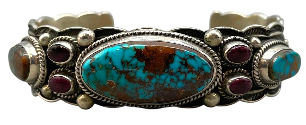 Sterling Silver, Turquoise And Sugilite Cuff Bracelet By Darrell Cadman: For your bidding enjoyment we present a sterling silver, turquoise and sugilite cuff bracelet. This piece features three nice turquoise and four sugilite cabochons all set in smooth silver bezels. Sur