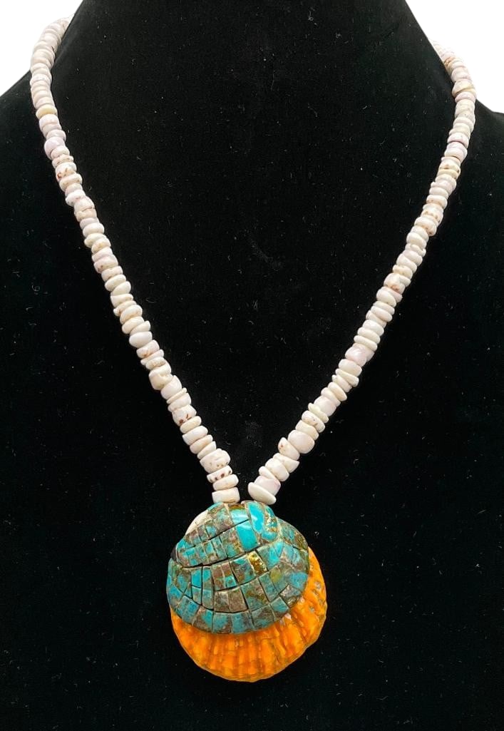 Vintage Pueblo Shell Necklace: Offered here for your consideration is a vintage Pueblo shell necklace. This piece features a shell pendant highlighted with a turquoise cobblestone inlay. The pendant hangs from a strand of shell bea
